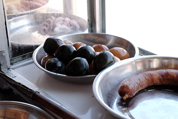 Century eggs, hard boiled eggs and Chinese sausage at the stall.
