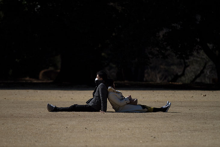 A young couple leaning against each other.