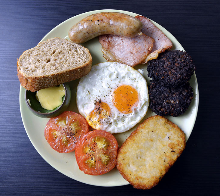 Dine on the full English with thick cut bacon, homemade sausages, tomatoes, hash browns, fried eggs and bread. The black pudding is an additional order.