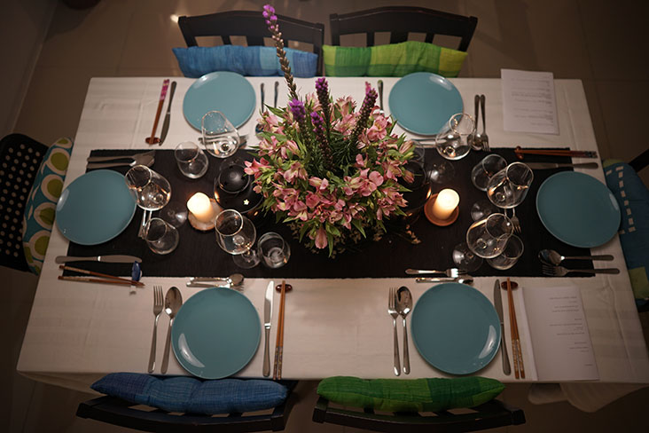 Intimate table setting with a fresh flower arrangement as the centrepiece.