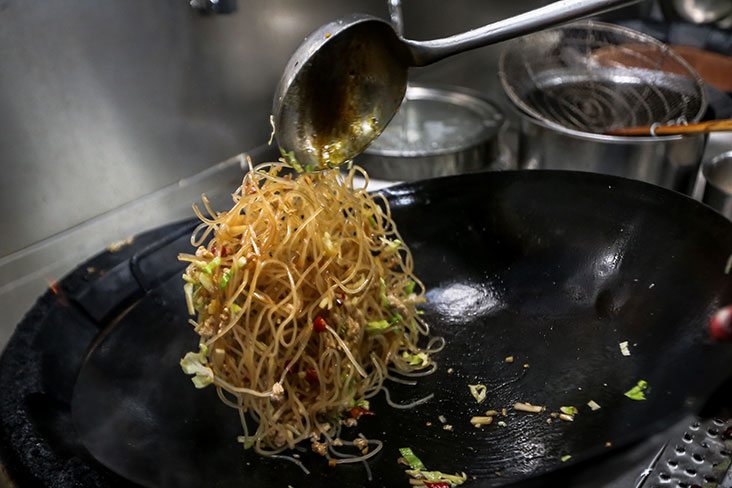 The translucent noodles are stir fried quickly with the minced meat, pickles and red chillies.
