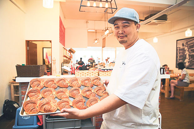 Eric Tan, one of the partners of Der Backmeister with a tray of freshly baked croissants