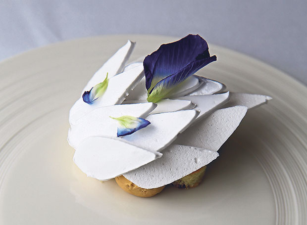 The gula Melaka dessert has teardrop shaped sour meringue and petals from bunga telang that cover a date sponge cake and a luscious gula Melaka marquise. This is served with a pulut ice-cream
