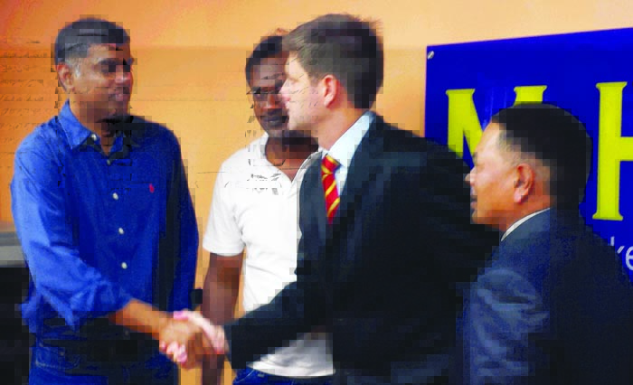 Revington gives Arul the best wishes as Dharma and MHC vice president Datuk Nur Azmi Ahmad look on.