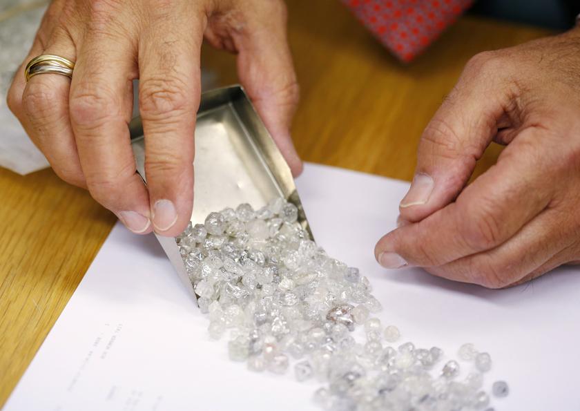 File picture showing diamond buyer Elliot Tannenbaum, from the Leo Schachter Diamond Group, looking at uncut diamonds from his company's allocation at a sight-holders week at De Beers offices in central London August 29, 2013. u00e2u20acu201d Reuters pic