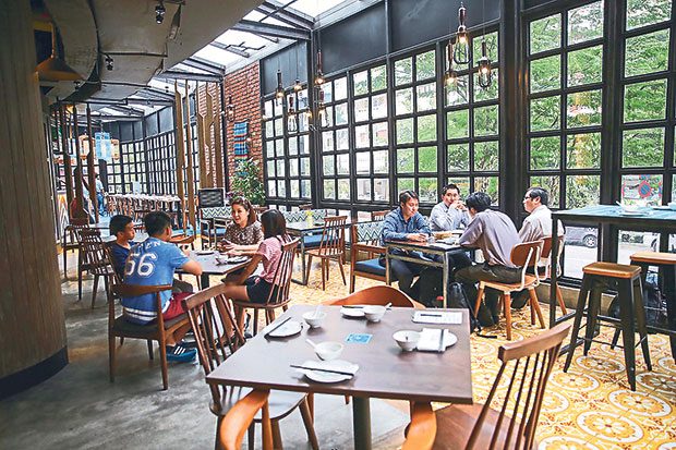 The dining space at Dolly Dim Sum is filled with natural sunlight pouring from its side glass windows.