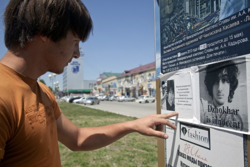 A man reads a placard in support to Dzhokhar Tsarnaev in Grozny on May 10, 2013. u00e2u20acu201d AFP pic