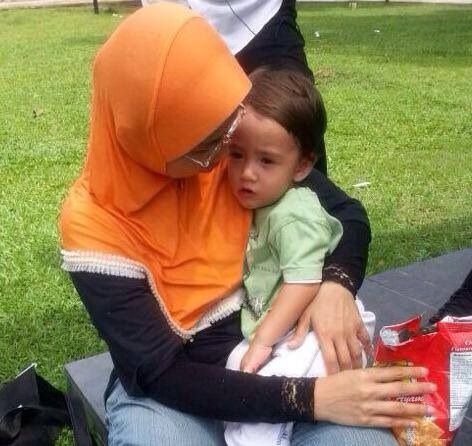 Freddy Joseph seen here with the woman who found him in Lake Titiiwangsa, Kuala Lumpur. — Picture by Choo Choy May