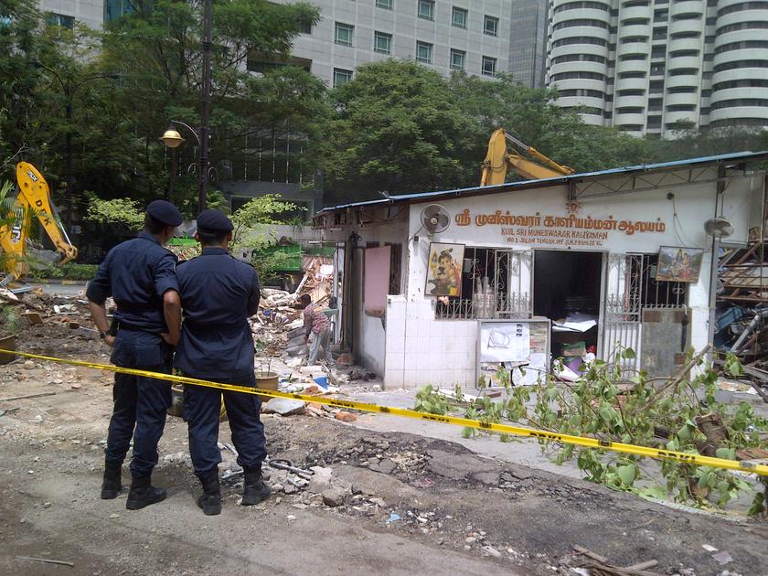 DBKL officers stand within the cordon around the shrine of the Golden Triangle Muneswarar Kuil in Kuala Lumpur November 10, 2013. u00e2u20acu201d Picture by Ida Lim