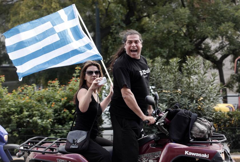 Extreme-right Golden Dawn party supporters celebrate outside the police headquarters in Athens. u00e2u20acu201d Reuters pic