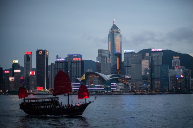 A junk sails on Victoria Harbour in front of the city's skyline in Hong Kong on June 3, 2013. The harbour waters is mostly crowded and often see high-speed hydrofoils vying for space and a century-old public ferry system connecting Hong Kong island to the