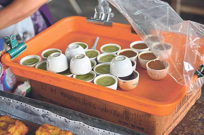 These sweet kuih in cups is scooped out and sprinkled with freshly grated coconut