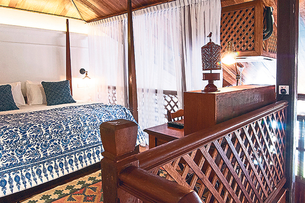 Family rooms have two four-poster beds, one on a loft and one below.