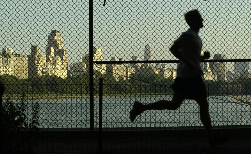 A man jogs along a path around the Central Park Reservoir with the buildings of Fifth Avenue in the backround in New York's famed Central Park, November 24, 2013. u00e2u20acu201d Reuters pic