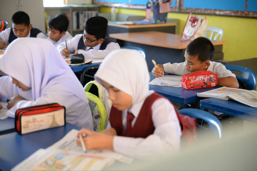 Standard Six pupil Faiz Aisha is busy in class at SK Sayong, Kuala Kangsar, Perak on January 12, 2015. u00e2u20acu201d Picture by K.E. Ooi