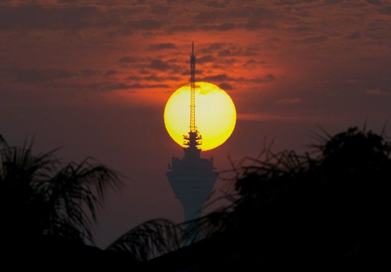 Malaysia's landmark KL Tower is silhouetted as the sun rises in Kuala Lumpur. — AFP file pic