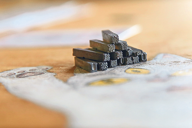 A close up of the lead type stacked to become a tower