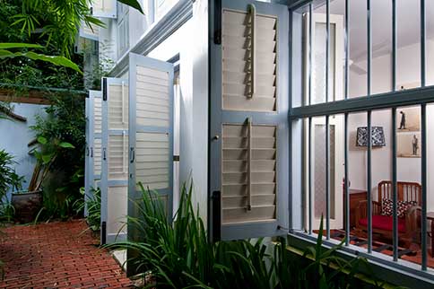 A throwback to the olden days when windows are left open for air ventilation and shielded by sheer cotton curtains.