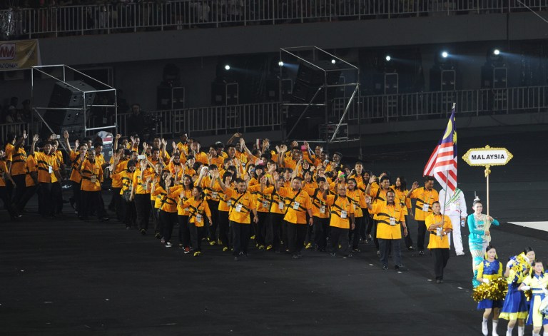 Malaysian athletes parade during the opening ceremony of the 27th Southeast Asian Games  in Naypyidaw on December 11, 2013. u00e2u20acu201d AFP pic