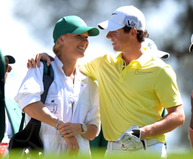 Photo dated April 10, 2013 shows Northern Ireland golfer Rory McIlroy (right) and his girlfriend tennis star Caroline Wozniacki of Denmark speaking as they play in the Par 3 Contest at the 77th Masters golf tournament in Augusta, Georgia. Two-time major g