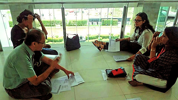 The panel of judges, led by head judge Bernice Chauly, discusses the merits of each poem