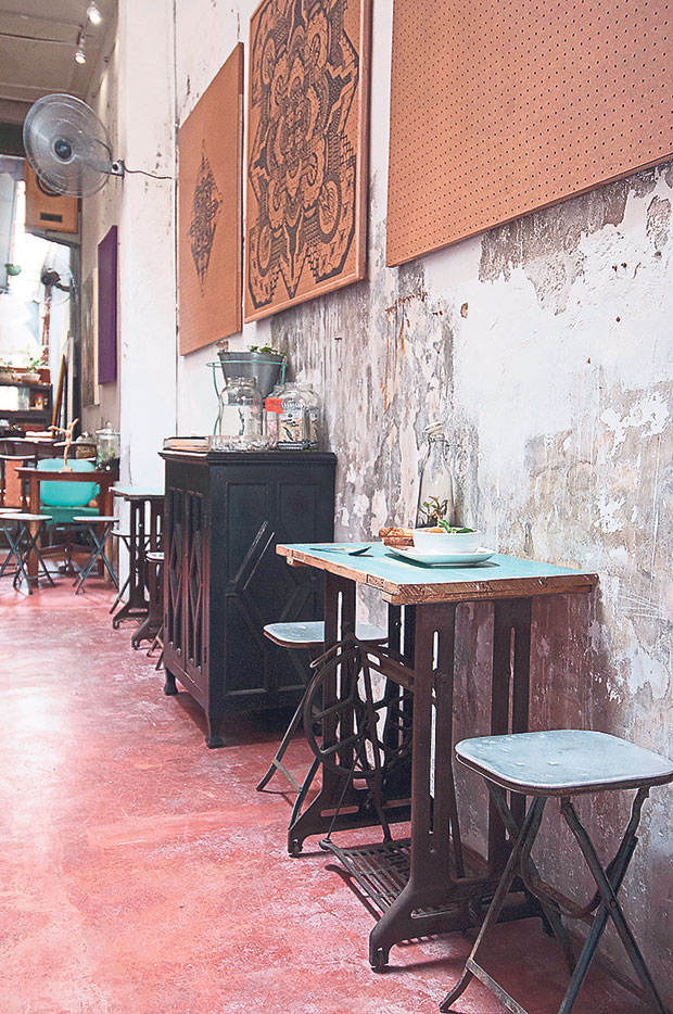 The refurbished base for old sewing machines is converted into small tables in the cafe