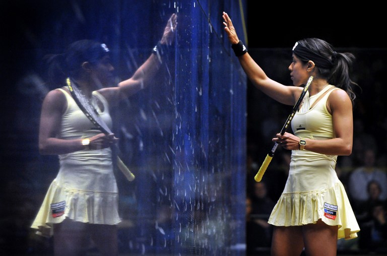 Nicol David of Malaysia (right) is reflected in the glass during the women's final against Laura Massaro of England at the Australian Open squash tournament in Canberra in August 19, 2012. u00e2u20acu201d AFP pic