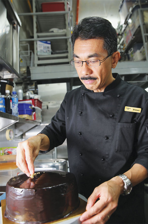 William Chong prepares the famous OMG! chocolate fudge cake