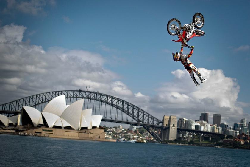 Josh Sheehan of Australia performs the opening jump in the Botanical Garden of Sydney in front of the Harbor Bridge and the Opera House to announce the final stage of the Red Bull X-Fighters World Tour on Cockatoo Island. u00e2u20acu201d AFP pic