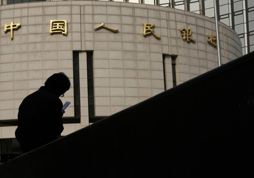 A man sits in front of the headquarters of the Peopleu00e2u20acu2122s Bank of China, the central bank, in Beijing October 17, 2013. u00e2u20acu201d Reuters pic