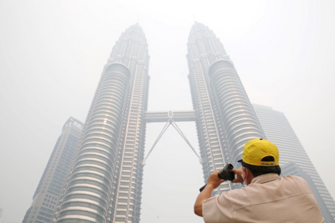The Petronas Twin Towers is seen covered in haze on June 24, 2013. Singapore and Malaysia have been plagued for decades by periodic haze from forest fires on Indonesiau00e2u20acu2122s Sumatra. u00e2u20acu201c Photo by Choo Choy May