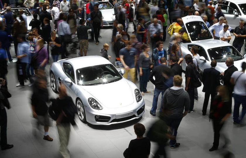 Visitors stroll over the stand of German car manufacturer Porsche to watch a Porsche Cayenne S at the Frankfurt Motor Show (IAA) September 14, 2013. u00e2u20acu201d Reuters pic