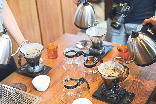 Students brewing coffee together