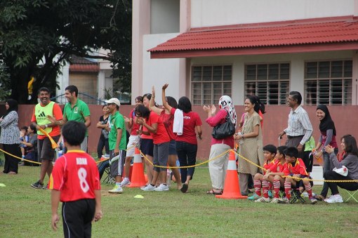 Parents cheer on their kids from the sidelines. Zaini says a lot of friendships are made in the league and many participants remain friends even after the league ends.