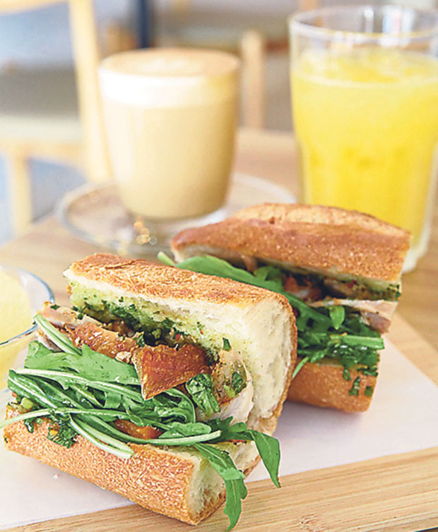 Porchetta sandwich uses baguette and is served with salsa verde. Order freshly squeezed orange juice or a latte with your mid-day indulgence