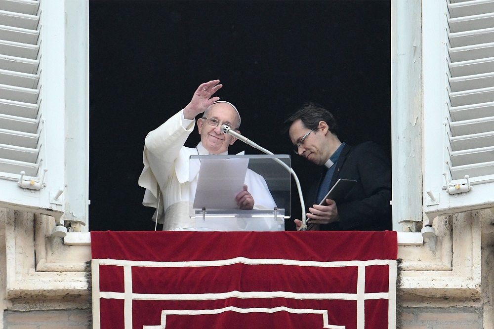 Pope Francis waves after he invited the faithful to download the u00e2u20acu02dcClick to Prayu00e2u20acu2122 app on a tablet computer (right), from the window of the Apostolic Palace overlooking St. Peteru00e2u20acu2122s square in the Vatican January 20, 2019. u00e2u20acu201d AFP pic