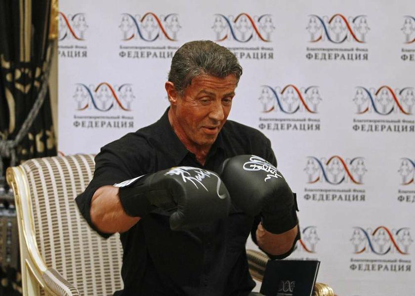 Actor Sylvester Stallone presents a pair of signed boxing gloves before a charity auction in St Petersburg October 26, 2013. u00e2u20acu201d Reuters pic 
