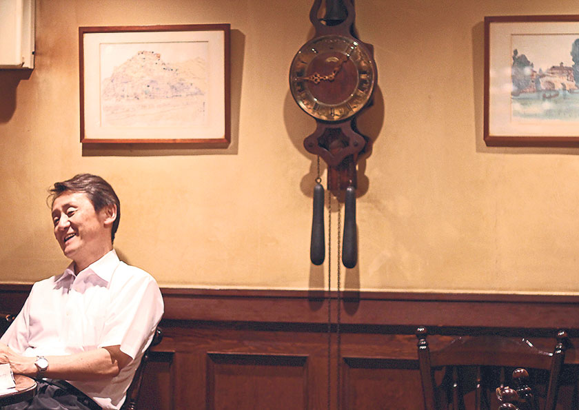 A regular relaxing in the tavern-like atmosphere of Coffee Tei