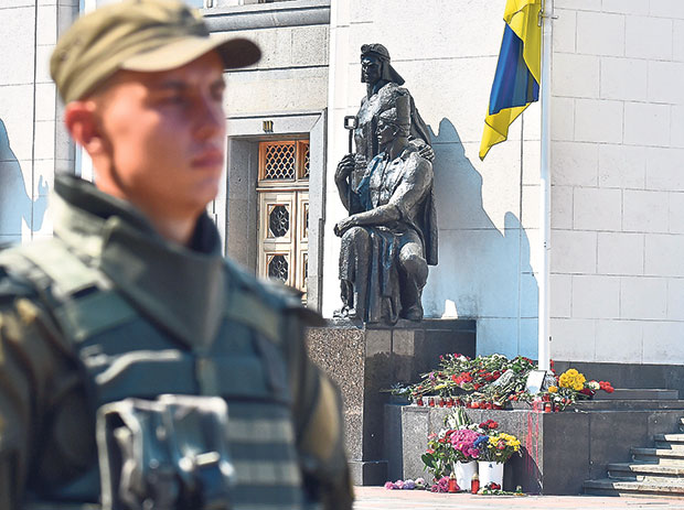 A police officer stands guard in front of the Ukrainian parliament in Kiev on September 1, 2015. — Picture by AFP