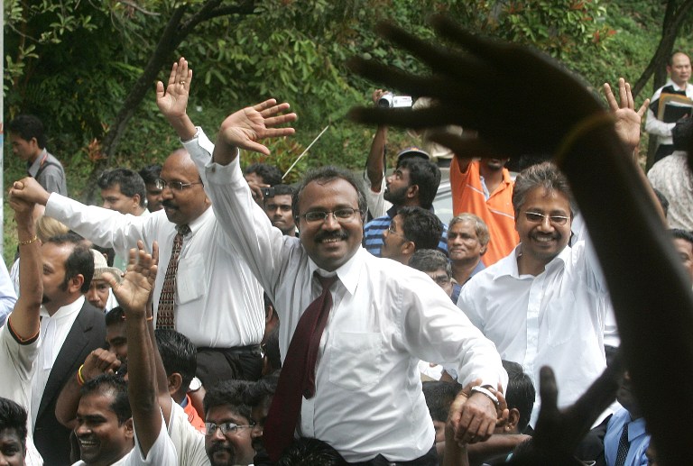 P.Uthayakumar, (centre), P. Waythamoorthy (right) and V. Ganapathy Rao (left) are lifted up by their supporters after being freed from a court in Klang, outside Kuala Lumpur, 26 November 2007. u00e2u20acu201d AFP pic