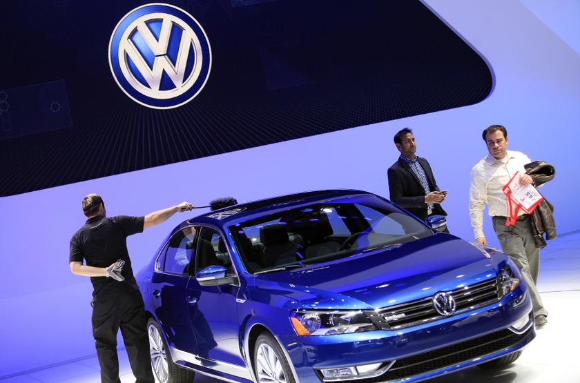 A worker dusts a Volkswagen Passat Blue Motion Concept as visitors look on during the North American International Auto Show in Detroit, Michigan January 15, 2014. u00e2u20acu201du00c2u00a0Reuters pic
