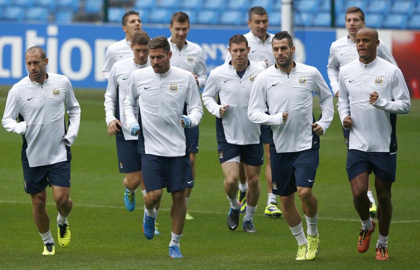 Manchester City's captain Vincent Kompany (right) warms up with team mates during a training session at the Etihad Stadium in Manchester, northern England, October 1, 2013. u00e2u20acu201d Reuters pic