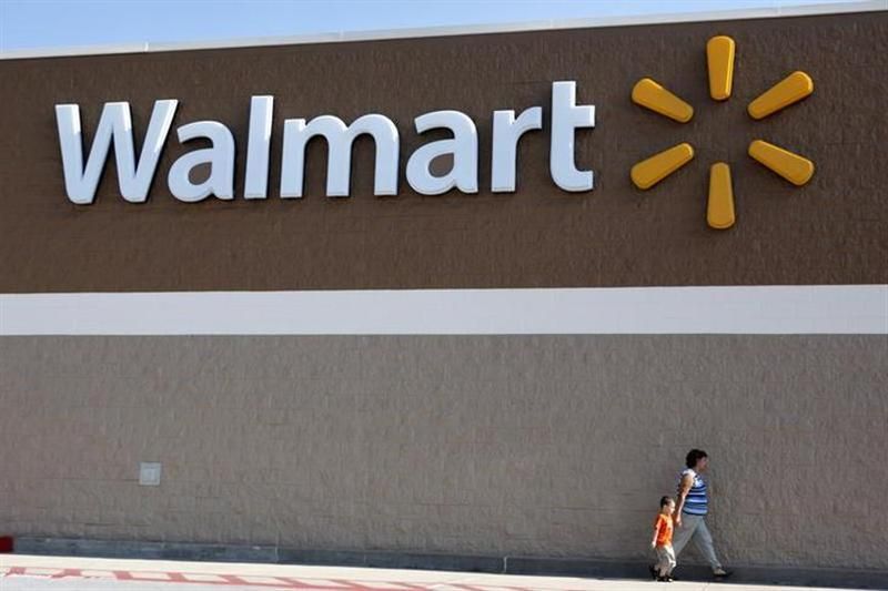 People walk past a Wal-Mart sign in Rogers, Arkansas. u00e2u20acu201d Reuters pic