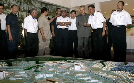 Former Malaysian Prime Minister Abdullah Ahmad Badawi being shown a diorama of the Iskandar development region in 2007. u00e2u20acu201c AFP pic