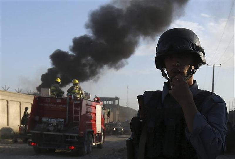 An Afghan policeman keeps watch as smoke rises from the site of an attack in Kabul, July 2, 2013.u00c2u00a0u00e2u20acu201d Reuters pic