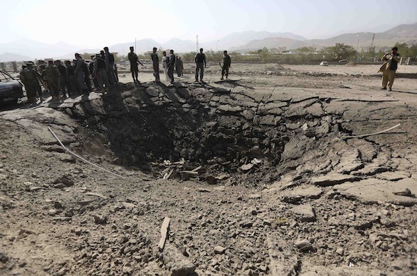 Afghan policemen look on near a crater at the scene of suicide attack in Maidan Shar, the capital of Wardak province, September 8, 2013. At least four Afghan intelligence agents were killed and more than one hundred people were wounded. u00e2u20acu201d Reuters pic