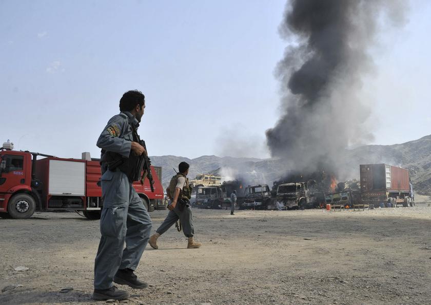 Afghan police inspect the site as smoke rises from burning NATO supply trucks after a Taliban attack at Torkham district in Jalalabad province Sept 2, 2013. u00e2u20acu201d Reuters pic