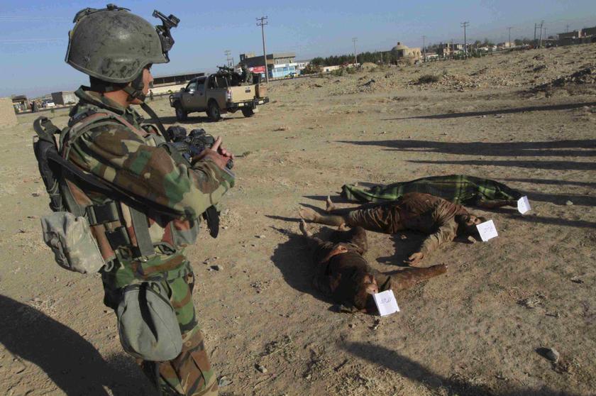 An Afghan National Army (ANA) soldier stands near the dead bodies of suspected Taliban insurgents after an operation in the Guzarah district of Herat province, Sept 1, 2013. u00e2u20acu201d Reuters pic
