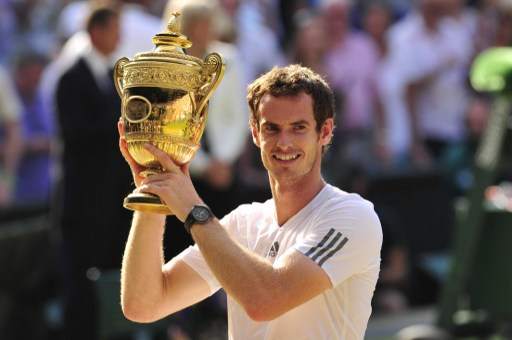 Britain's Andy Murray raises the winner's trophy after beating Serbia's Novak Djokovic in the men's singles final in the 2013 Wimbledon Championships tennis tournament on July 7, 2013. Murray won 6-4, 7-5, 6-4. u00e2u20acu201d AFP pic