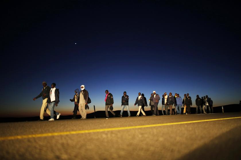 African migrants walk on a road after choosing to permanently leave their open detention facility, which began operating last week in the southern Israeli desert December 15, 2013. u00e2u20acu201d Reuters pic